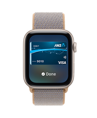 Apple Watch SE 3, aluminium case, starlight colour, screen shows Wallet, payment card graphic, right side exterior, Digital Crown dial, Sport Loop band, chambray blue colour (light blue-grey)