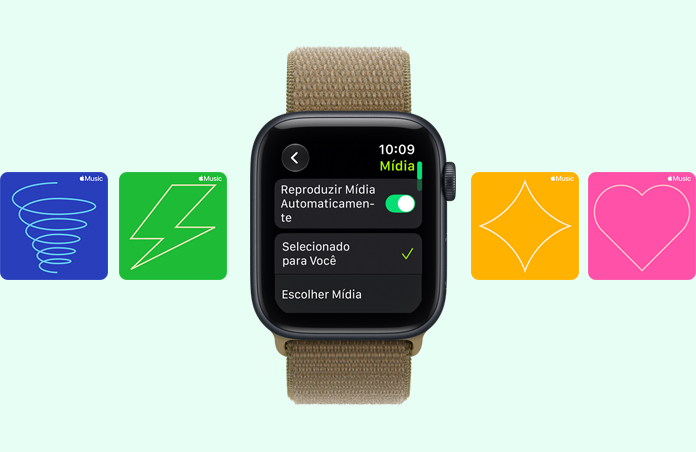 Apple Watch SE 3 com caixa meia-noite de alumínio e pulseira loop esportiva na cor oliva (verde terroso) mostram o reprodutor de mídia na tela. No lado direito, a Digital Crown. Ao fundo, cartões gráficos do Apple Music com ilustrações de redemoinho, raio, diamante e coração