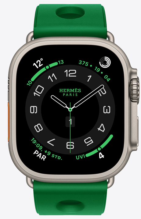 Apple Watch Hermès Ultra 4, analoges Circulaire Zifferblatt, (Stunden-, Minuten- und Sekundenzeiger, Komplikationen: Wetter, Aktivitätsringe, Paris Zeit und UV Index), Titangehäuse, Farbe Natur, rechte Seitenansicht, Digital Crown, erhöhte Seitentaste, kombiniert mit Scub’H Diving Armband, Farbe Vert Vertigo (Hellgrün), geformtes Gummimaterial, kreisförmige Aussparungen in der Mitte