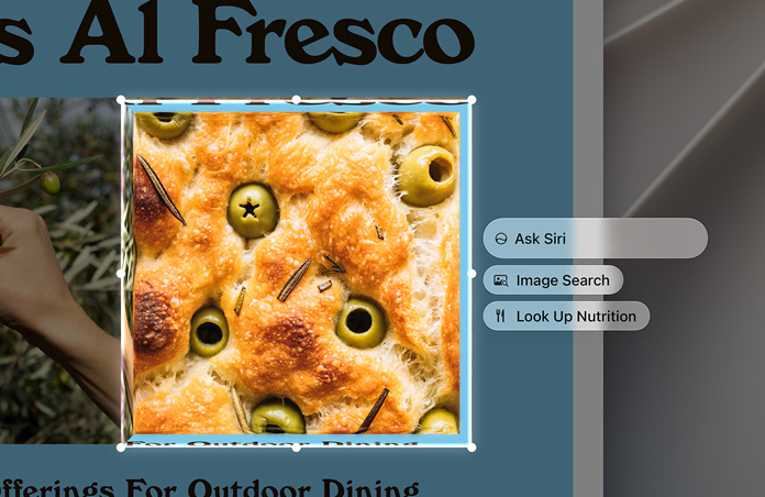 Egy olívás focaccia kijelölt képe mellett az „Ask Siri” (Kérje meg Sirit), az „Image Search” (Képkeresés) és a „Look Up Nutrition” (Tápanyagok definiálása) lehetőségek szerepelnek.