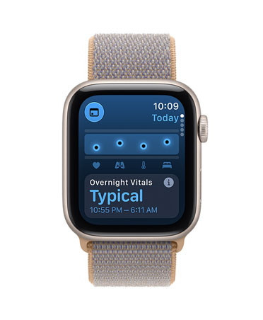 Apple Watch SE 3, screen shows overnight vitals, aluminium case, starlight colour, right side exterior, Digital Crown dial, connected to Sport Loop strap, chambray blue colour (light blue-grey)