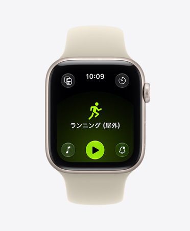 スターライトアルミニウムケースのApple Watch SE 3。画面にワークアウトアプリ（屋外ランニング）が表示されている。右側面の外観、Digital Crownのダイヤル。サンド（ライトタン）のスポーツバンド