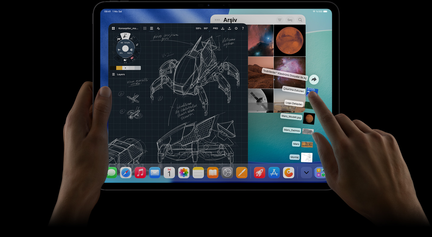 iPad Pro, önden dış görünüm, yatay pozisyonda, sol el aygıtı tutuyor, sağ el yelpaze şeklinde açılmış İndirilenler klasörü dosyalarına işaret ediyor, ekranda ayrıntılı robot projelerinin, el yazısı notların ve çok sayıda tasarım aşamasının yer aldığı bir fotoğraf düzenleme uygulaması dahil birden fazla uygulamanın ve Fotoğraflar Arşivi’nin açık olduğu iPadOS arayüzü gösteriliyor
