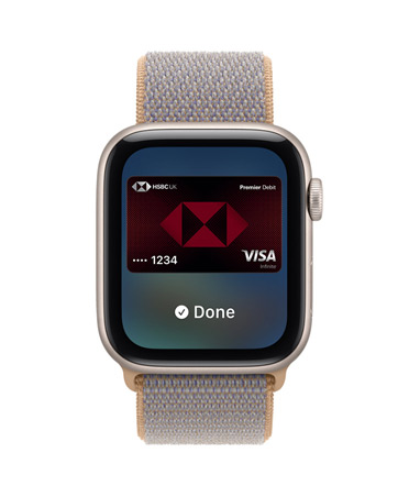 Apple Watch SE 3, aluminum case, starlight color, screen shows Wallet, payment card graphic, right side exterior, Digital Crown dial, Sport Loop band, chambray blue color (light blue-gray)