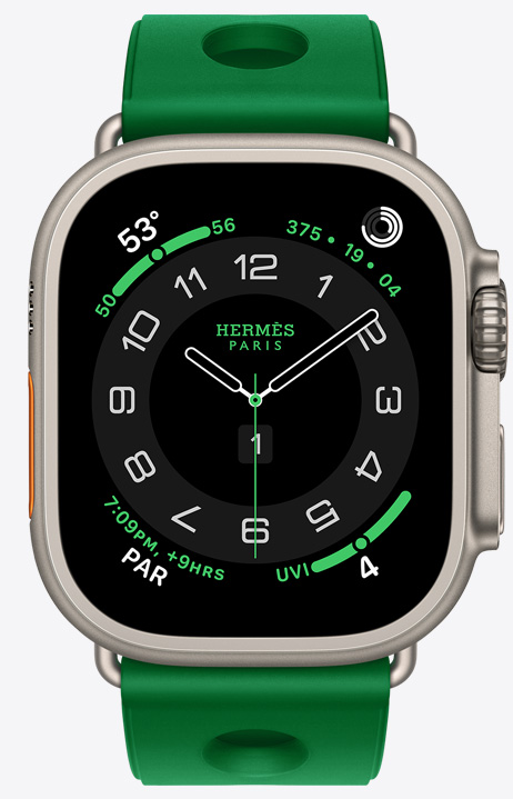 Apple Watch Hermès Ultra 4, Circulaire analog watch face, (hour, minute and second hands, complications: Weather, Activity rings, Paris time and UV index), titanium case, natural color, right side exterior, Digital Crown, raised side button, paired with Scub'H Diving band, Vert Vertigo color (bright green), molded rubber material, circular cutouts centered